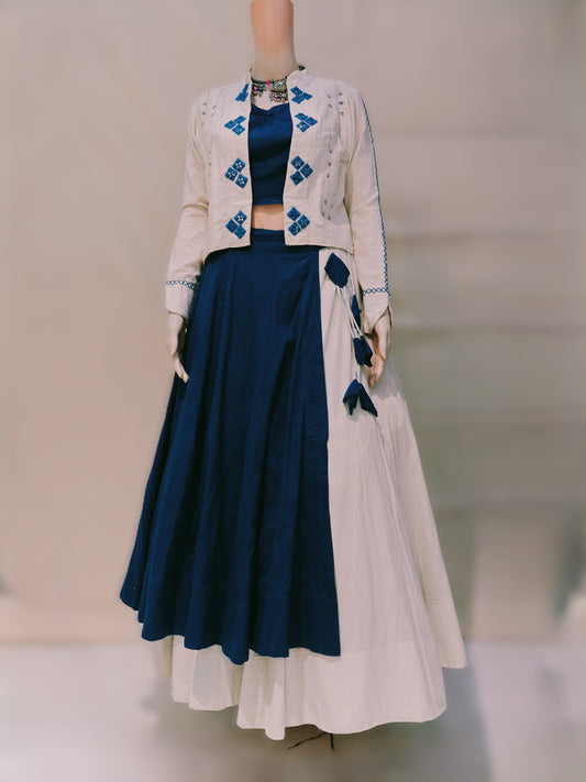 Mannequin wearing a navy blue and white outfit with embroidered details on a neutral background