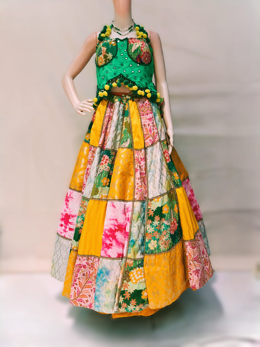 Colorful patchwork dress on a mannequin against a neutral background